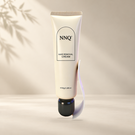 NNQ Hair Removal Cream 100 g tube with included scraper in a warm ivory setting